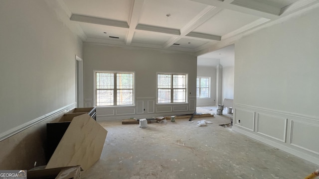 empty room featuring beamed ceiling, a high ceiling, and coffered ceiling