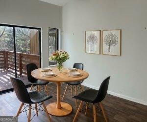 dining area featuring vaulted ceiling and dark hardwood / wood-style floors