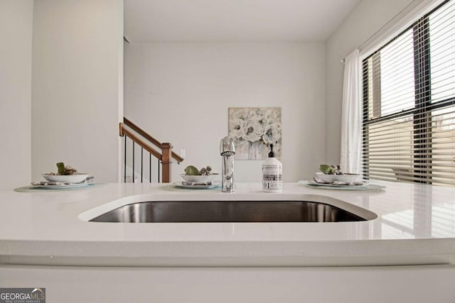 kitchen featuring light countertops and a sink