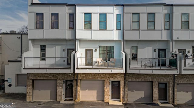 view of building exterior featuring a garage and driveway