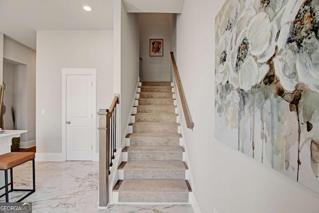stairs featuring recessed lighting, marble finish floor, and baseboards