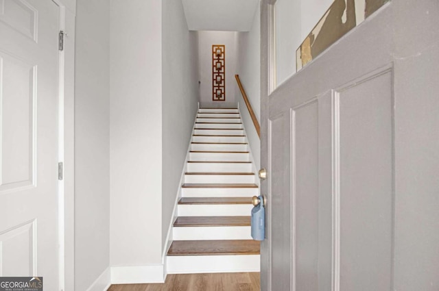 stairs with baseboards and wood finished floors