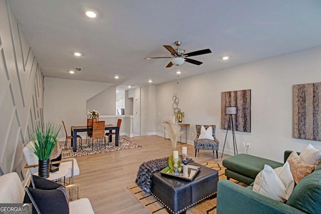 living room featuring recessed lighting, visible vents, a ceiling fan, light wood-type flooring, and baseboards