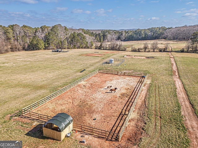 aerial view featuring a forest view and a rural view