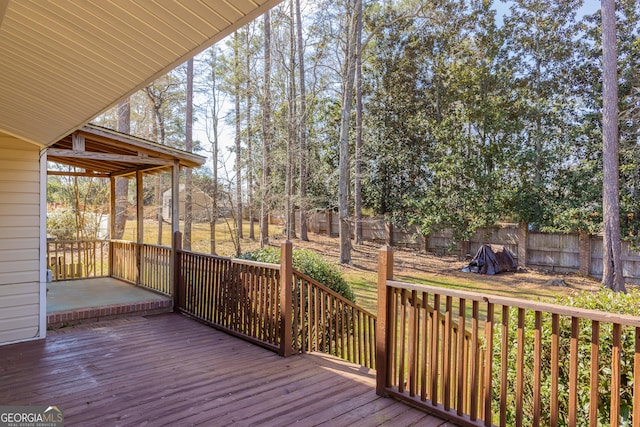 wooden deck featuring a sunroom and a fenced backyard