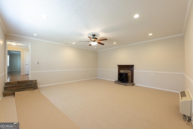 unfurnished living room featuring a stone fireplace, recessed lighting, carpet flooring, baseboards, and ornamental molding