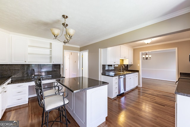 kitchen with a notable chandelier, open shelves, stainless steel dishwasher, white cabinetry, and a kitchen island