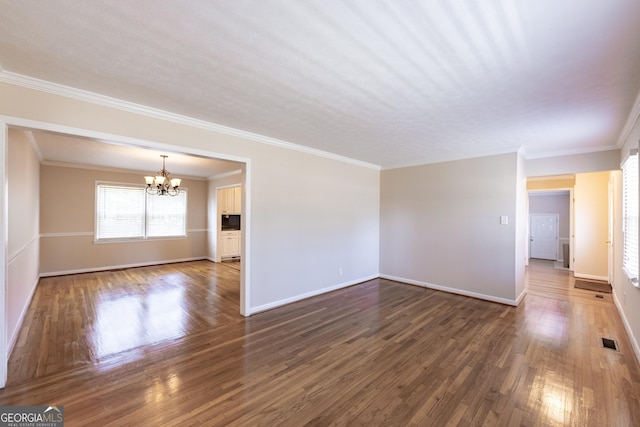 unfurnished living room with an inviting chandelier, baseboards, visible vents, and dark wood-style flooring