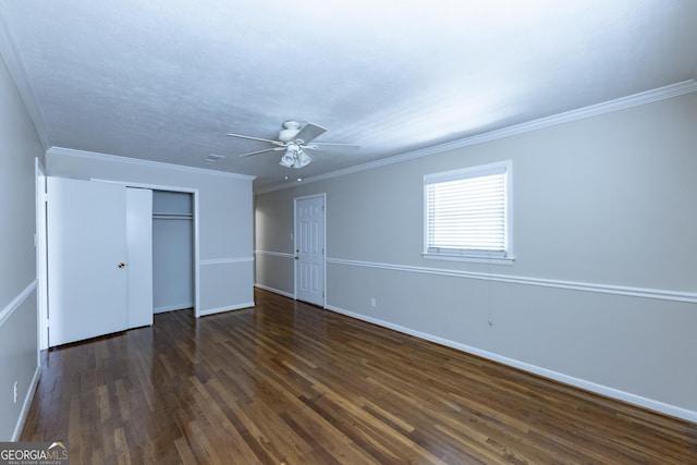 unfurnished bedroom with ceiling fan, dark wood-style flooring, baseboards, ornamental molding, and a closet