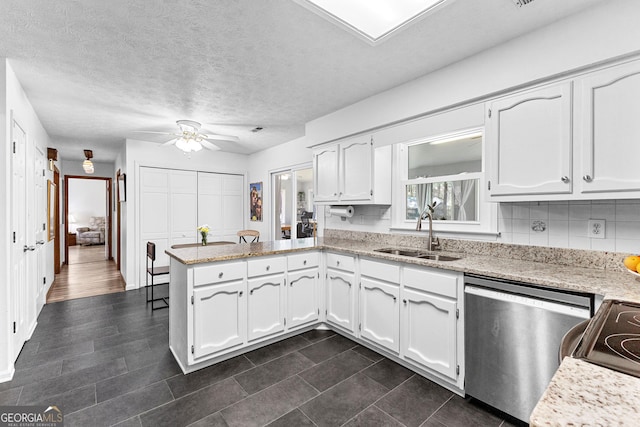 kitchen with sink, white cabinetry, stainless steel dishwasher, kitchen peninsula, and decorative backsplash