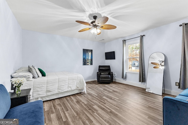 bedroom with hardwood / wood-style flooring and ceiling fan