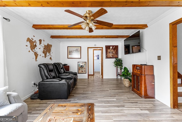 living room featuring light hardwood / wood-style floors, crown molding, and beam ceiling