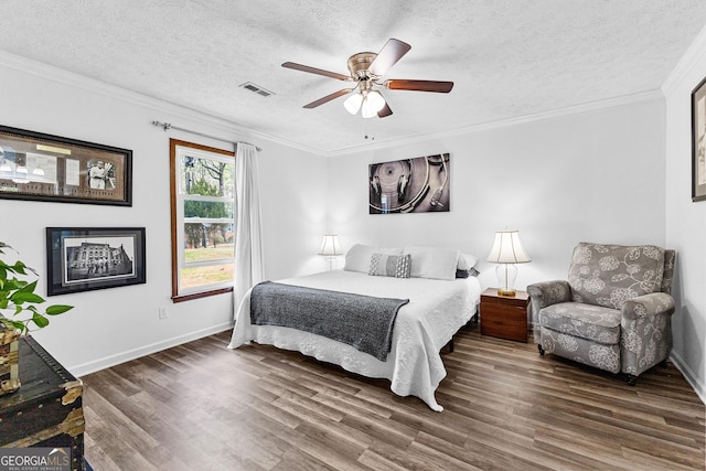 bedroom featuring a textured ceiling, ceiling fan, dark hardwood / wood-style floors, and ornamental molding