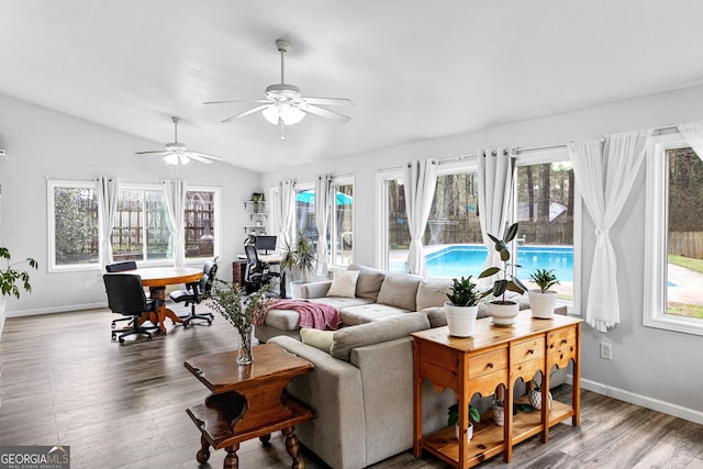 sunroom / solarium featuring vaulted ceiling, ceiling fan, and a wealth of natural light