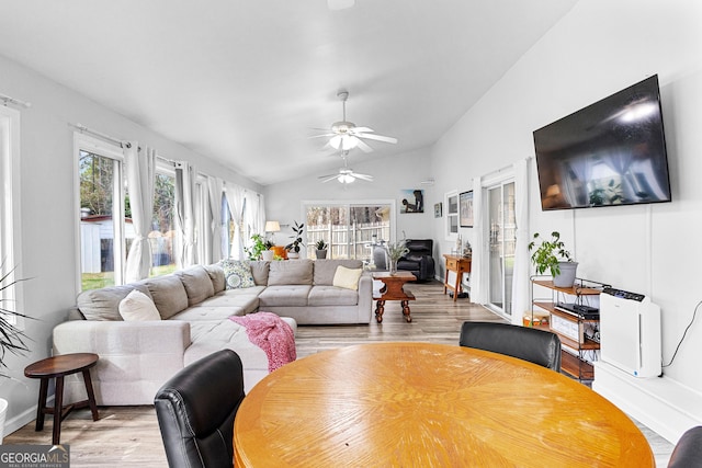 living room featuring light wood-type flooring, lofted ceiling, and ceiling fan