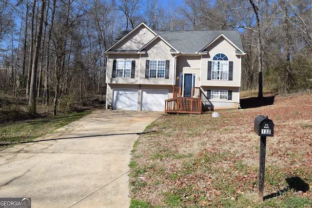 split foyer home with driveway and a garage