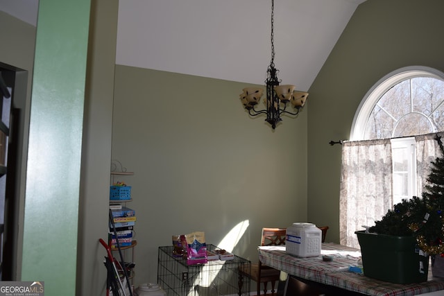 dining space with a notable chandelier and vaulted ceiling