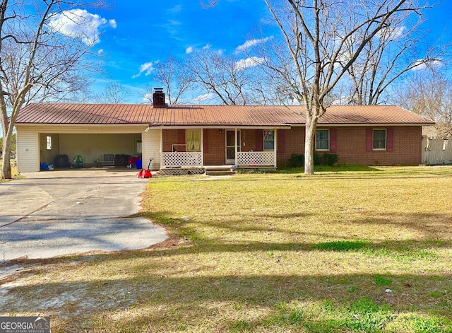 ranch-style home with a chimney, covered porch, concrete driveway, a carport, and a front lawn