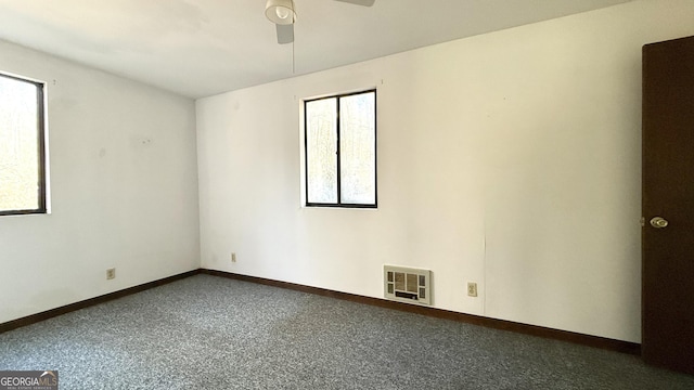 carpeted spare room with ceiling fan and a wealth of natural light