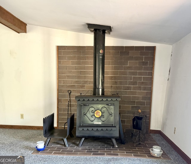 room details with a wood stove and beam ceiling