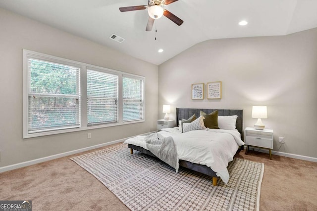 carpeted bedroom with vaulted ceiling and ceiling fan