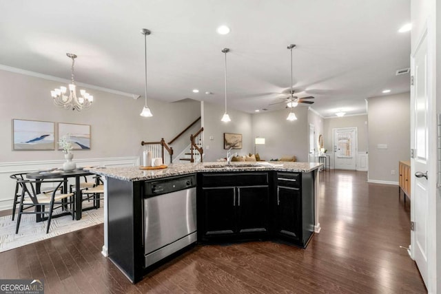 kitchen with an island with sink, pendant lighting, sink, and stainless steel dishwasher