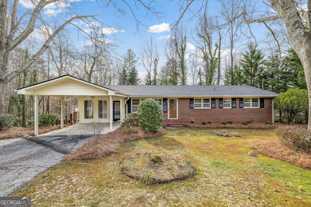 single story home with a front yard and a carport