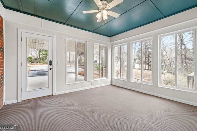 unfurnished sunroom with ceiling fan and a wealth of natural light