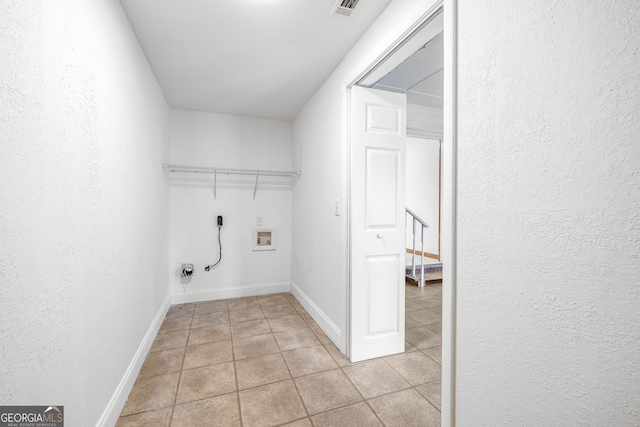 clothes washing area featuring light tile patterned floors, electric dryer hookup, and hookup for a washing machine