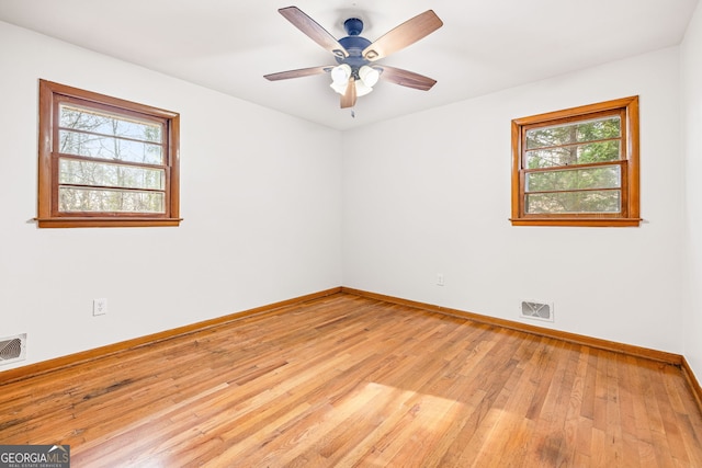 unfurnished room featuring ceiling fan, light hardwood / wood-style floors, and a healthy amount of sunlight