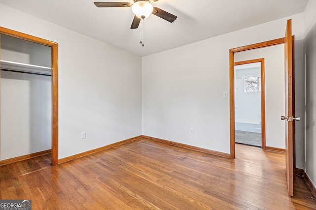 unfurnished bedroom featuring hardwood / wood-style flooring and ceiling fan