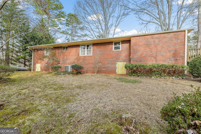 view of side of property with a yard and cooling unit