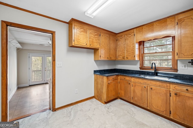 kitchen with ceiling fan, sink, and dark stone counters