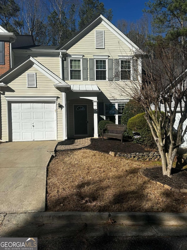 traditional home featuring driveway and an attached garage