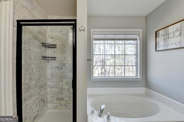 full bath with a garden tub, a textured ceiling, and a stall shower