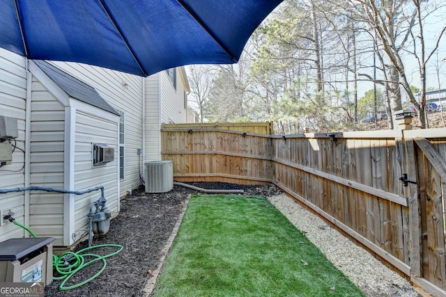 view of yard featuring a fenced backyard and cooling unit