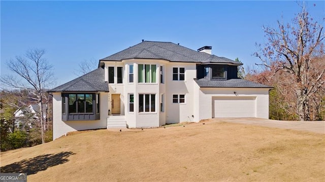 view of front of property featuring stucco siding, a chimney, a front yard, a garage, and dirt driveway