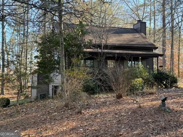 view of side of home featuring a chimney