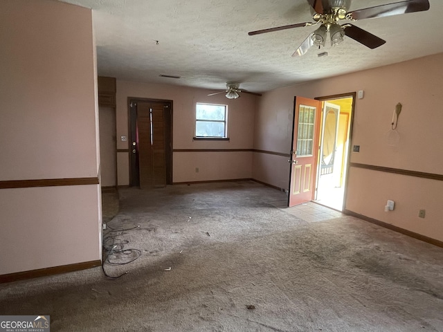 unfurnished room with visible vents, baseboards, a textured ceiling, and light colored carpet