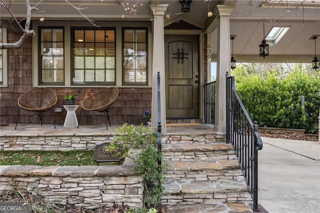 view of exterior entry with a porch