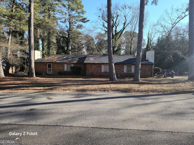 single story home with a chimney