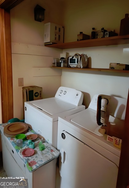 clothes washing area featuring washing machine and dryer and laundry area