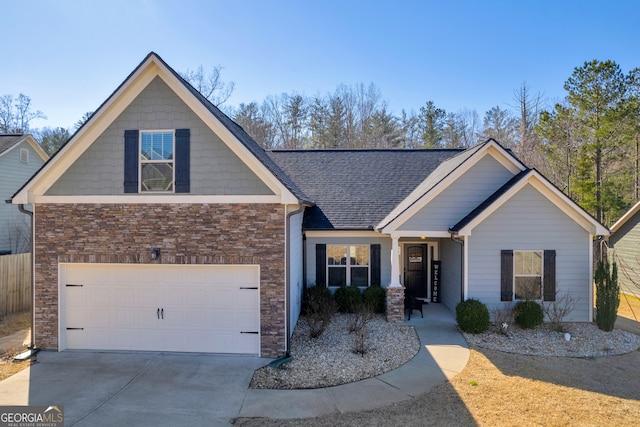 craftsman-style house with stone siding, a shingled roof, a garage, concrete driveway, and fence