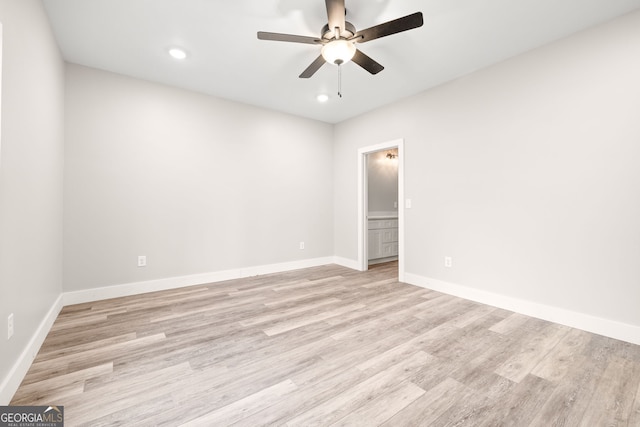 spare room featuring light wood finished floors, baseboards, a ceiling fan, and recessed lighting