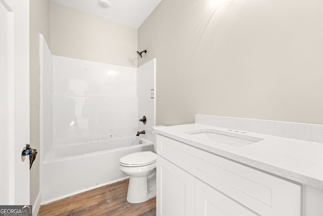 bathroom with shower / bathing tub combination, vanity, toilet, and wood finished floors