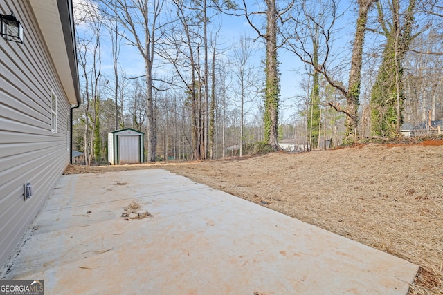 view of patio featuring a shed and an outbuilding