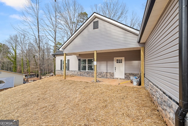 exterior space featuring stone siding