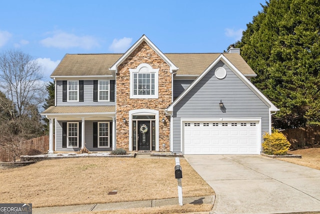 view of front of property with a front yard and a garage