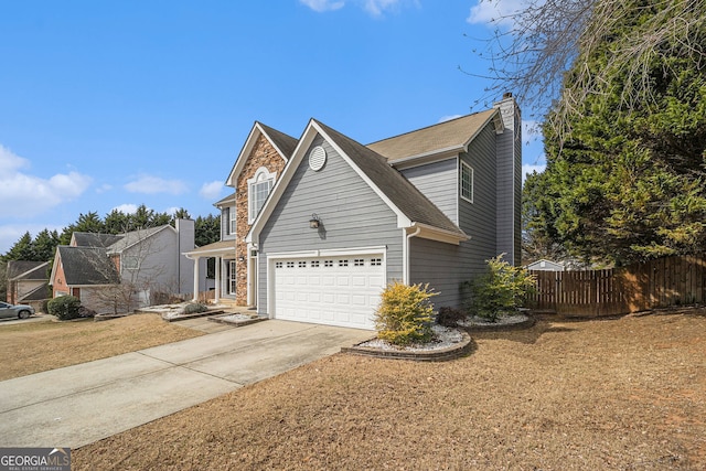 traditional-style house featuring an attached garage, fence, concrete driveway, a chimney, and a front yard