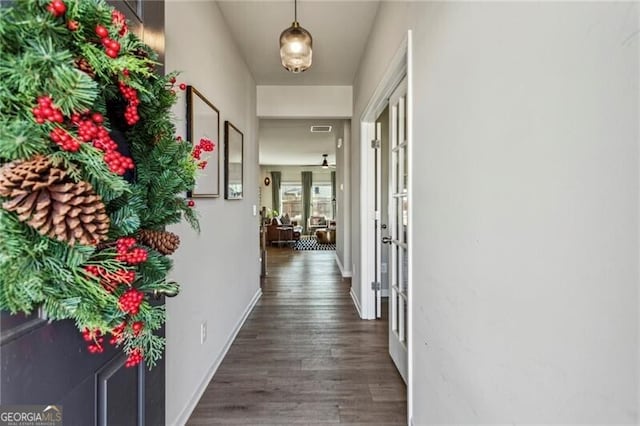 corridor featuring french doors, wood finished floors, visible vents, and baseboards